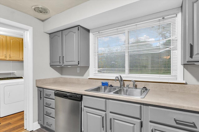 724 Dover Pl, Champaign, IL 61820 - kitchen with stainless steel dishwasher, gray cabinetry, washer / dryer, wood finished floors, and light countertops