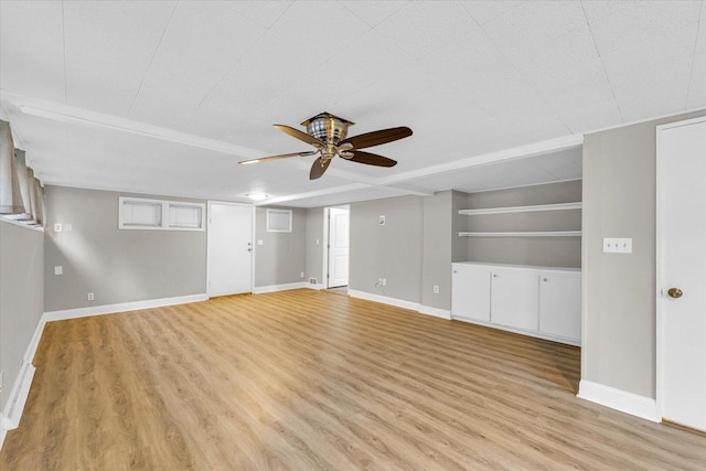 724 Dover Pl, Champaign, IL 61820 - unfurnished living room with light wood-type flooring, a ceiling fan, and built in features