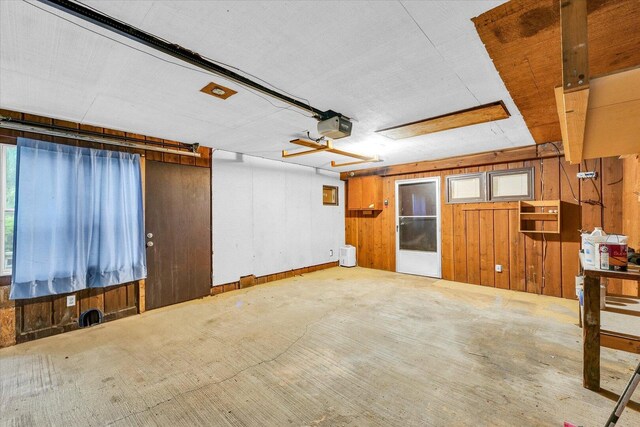 724 Dover Pl, Champaign, IL 61820 - empty room with wood walls and plenty of natural light