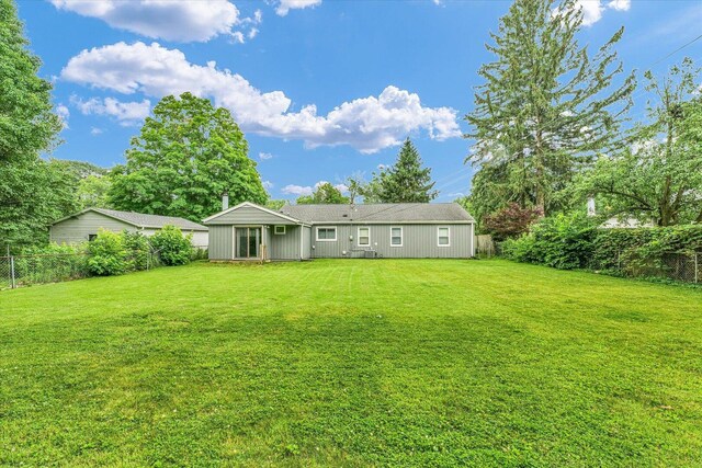 724 Dover Pl, Champaign, IL 61820 - back of house with a fenced backyard