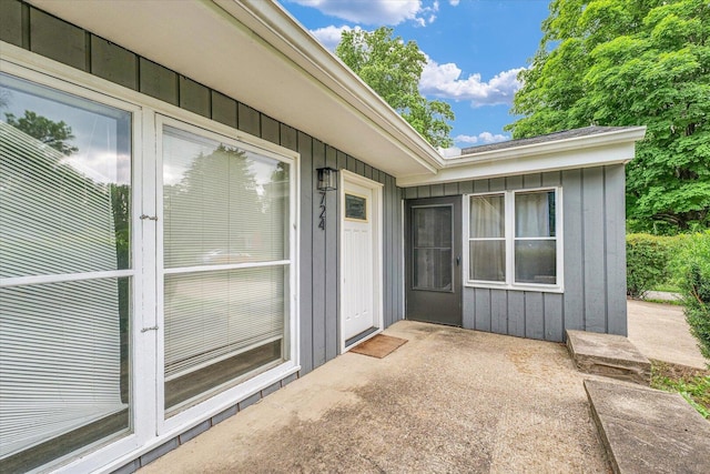 724 Dover Pl, Champaign, IL 61820 - property entrance with board and batten siding and a patio area