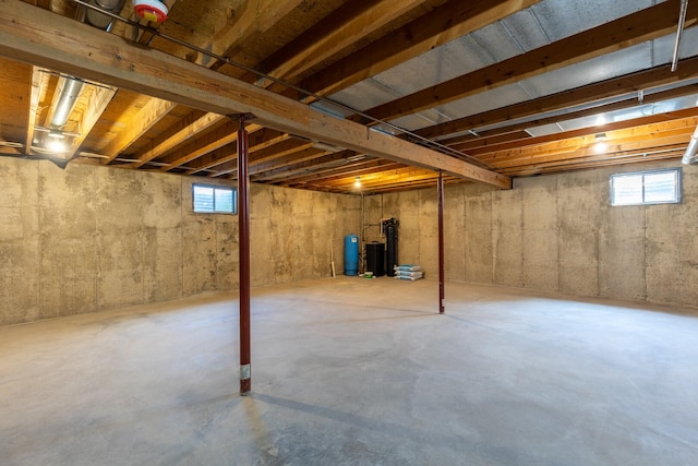 3472 N Il St Unit 23, Ottawa, IL 61350 - below grade area featuring a water pressure tank, healthy amount of natural light, and a water softener system