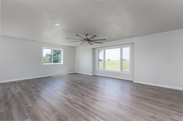 3472 N Il St Unit 23, Ottawa, IL 61350 - empty room with wood finished floors, a textured ceiling, and a ceiling fan