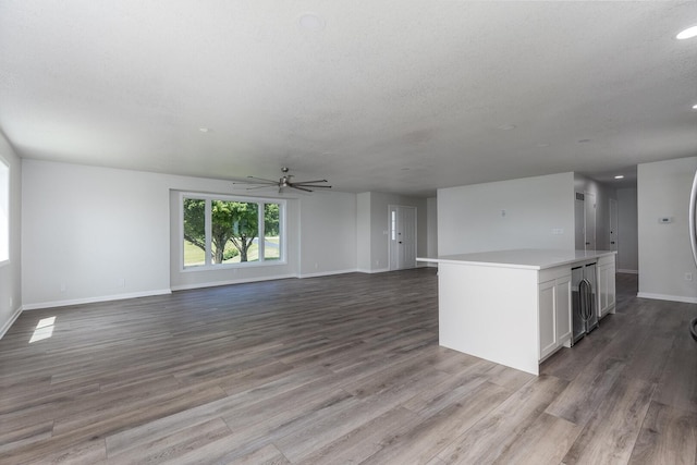 3472 N Il St Unit 23, Ottawa, IL 61350 - unfurnished living room featuring ceiling fan, wood finished floors, recessed lighting, and a textured ceiling