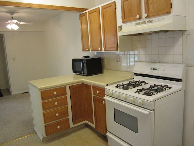 1769 Sessions Walk Unit C, Hoffman Estates, IL 60169 - kitchen with white range with gas stovetop, black microwave, under cabinet range hood, a peninsula, and a ceiling fan