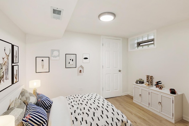 9811 S Woodlawn Ave, Chicago, IL 60628 - bedroom featuring light wood-style floors and baseboards