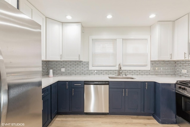 9811 S Woodlawn Ave, Chicago, IL 60628 - kitchen with appliances with stainless steel finishes, light countertops, white cabinetry, and recessed lighting