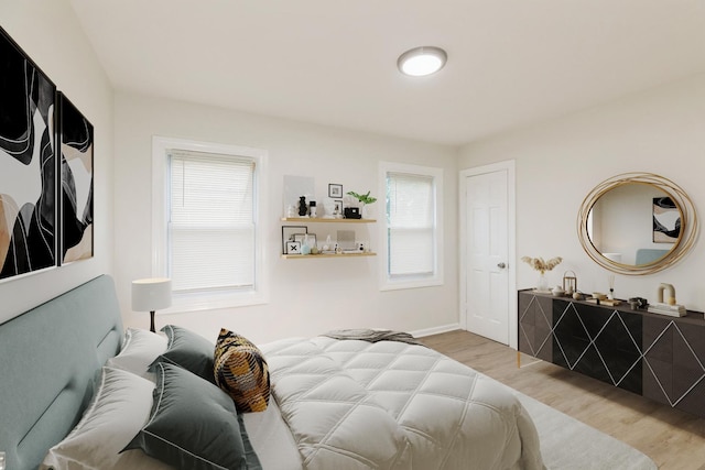 9811 S Woodlawn Ave, Chicago, IL 60628 - bedroom with light wood-style floors and baseboards