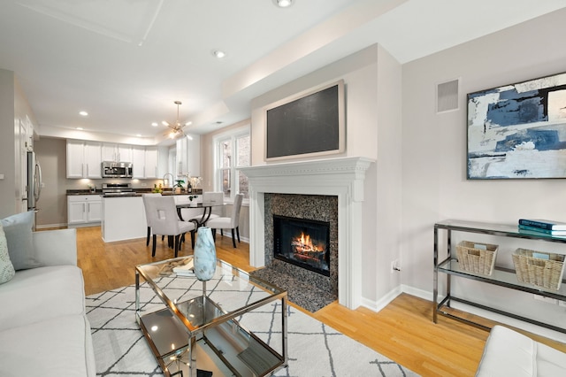 1242 W Ohio St Unit 2E, Chicago, IL 60642 - living room featuring light wood-type flooring, recessed lighting, and a fireplace with flush hearth