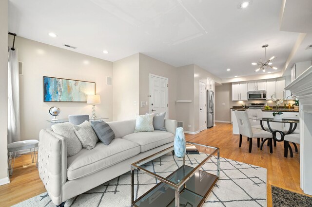 1242 W Ohio St Unit 2E, Chicago, IL 60642 - living room with light wood-style flooring, a chandelier, and recessed lighting