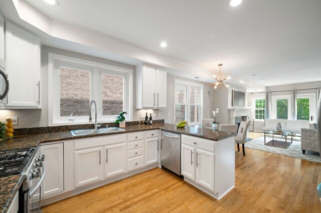 1242 W Ohio St Unit 2E, Chicago, IL 60642 - kitchen featuring stainless steel appliances, white cabinetry, light wood-style floors, and recessed lighting