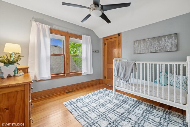 128 Coolidge Ave, Barrington, IL 60010 - bedroom featuring vaulted ceiling, wood finished floors, a ceiling fan, and a nursery area