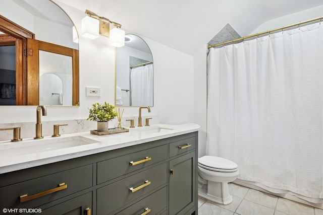 128 Coolidge Ave, Barrington, IL 60010 - full bathroom with double vanity, curtained shower, vaulted ceiling, and tile patterned flooring