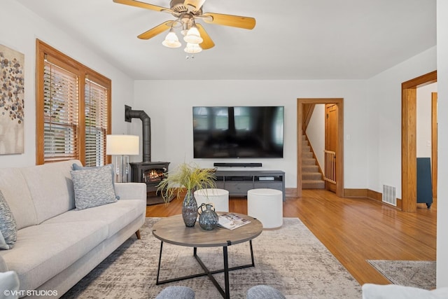 128 Coolidge Ave, Barrington, IL 60010 - living area with a wood stove, wood finished floors, stairs, and ceiling fan
