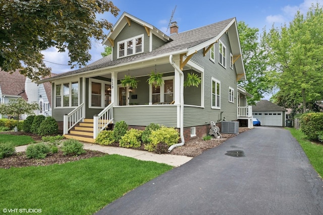 128 Coolidge Ave, Barrington, IL 60010 - bungalow-style home with a shingled roof, a detached garage, a chimney, an outbuilding, and a front yard
