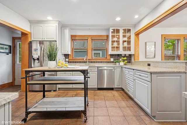 128 Coolidge Ave, Barrington, IL 60010 - kitchen with appliances with stainless steel finishes, decorative backsplash, recessed lighting, white cabinetry, and glass insert cabinets