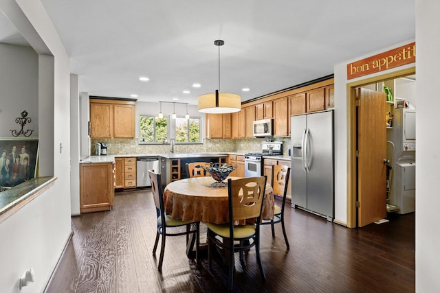 1018 Butterfield Cir E, Shorewood, IL 60404 - dining room with dark wood-style flooring, stacked washer / dryer, and recessed lighting