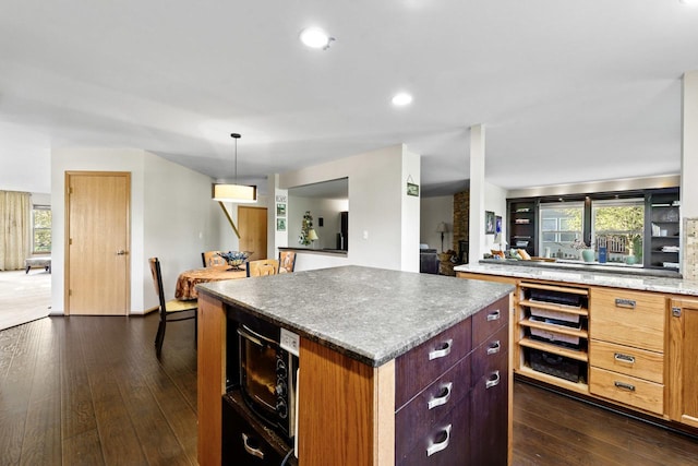1018 Butterfield Cir E, Shorewood, IL 60404 - kitchen featuring dark wood-type flooring, a center island, plenty of natural light, recessed lighting, and decorative light fixtures