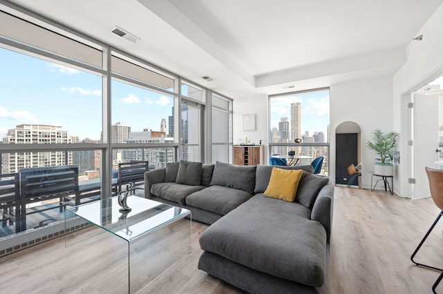 303 W Ohio St Unit 2302, Chicago, IL 60654 - living area with a view of skyline, wood finished floors, and a wall of windows