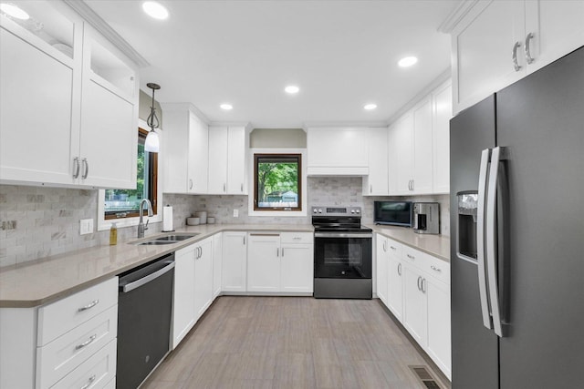 20 Park Dr, Villa Grove, IL 61956 - kitchen featuring stainless steel appliances, white cabinets, backsplash, recessed lighting, and decorative light fixtures