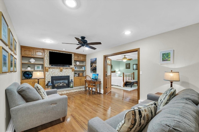 20 Park Dr, Villa Grove, IL 61956 - living area with a fireplace, light wood-style flooring, a ceiling fan, and recessed lighting