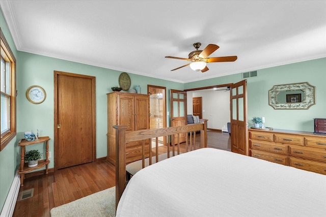 20 Park Dr, Villa Grove, IL 61956 - bedroom featuring wood finished floors, a baseboard radiator, crown molding, and a ceiling fan