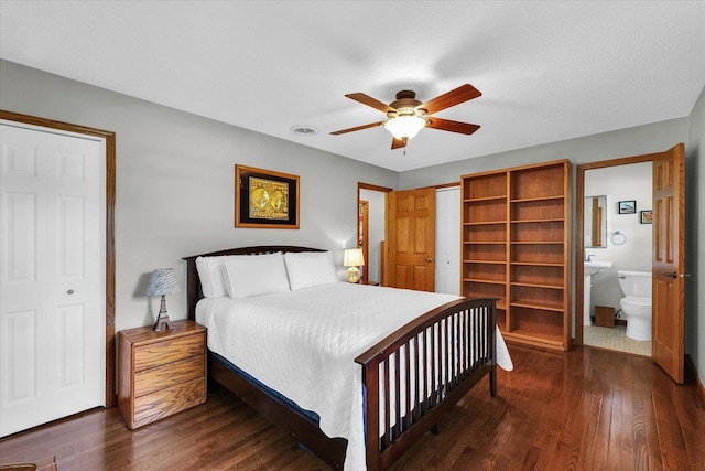 20 Park Dr, Villa Grove, IL 61956 - bedroom featuring dark wood-type flooring, a closet, connected bathroom, and a ceiling fan