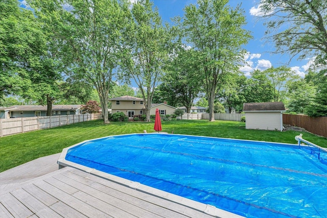 20 Park Dr, Villa Grove, IL 61956 - view of pool featuring a fenced backyard, a wooden deck, and a storage shed