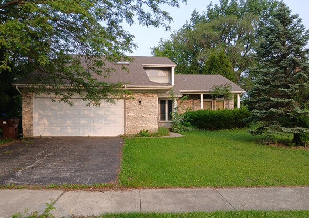 540 Homan Ave, Park Forest, IL 60466 - view of front of property with asphalt driveway, a front lawn, and an attached garage