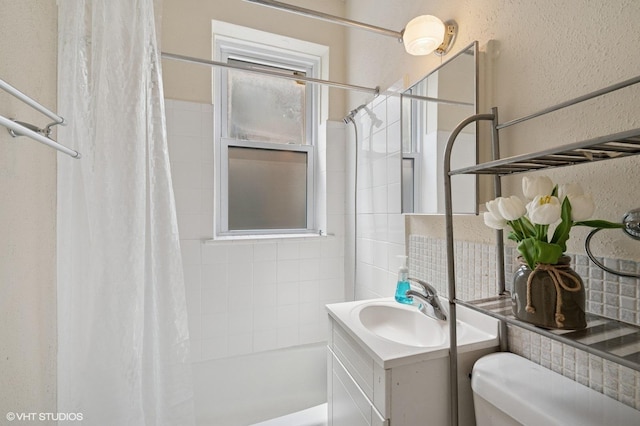 902 W Margate Ter Unit 2D, Chicago, IL 60640 - bathroom with a textured wall, shower / bathtub combination with curtain, and vanity