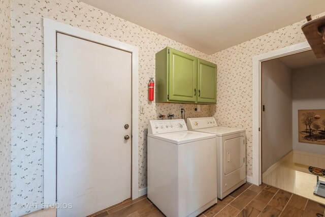 1954 Greenview St, Valparaiso, IN 46383 - washroom featuring washer and clothes dryer, dark wood-style floors, wallpapered walls, and cabinet space