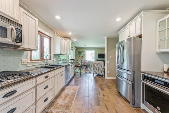 1954 Greenview St, Valparaiso, IN 46383 - kitchen with stainless steel appliances, light wood-style floors, decorative backsplash, white cabinets, and recessed lighting