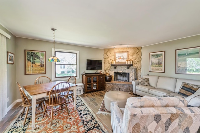 1954 Greenview St, Valparaiso, IN 46383 - living room featuring a stone fireplace, wood finished floors, track lighting, and ornamental molding