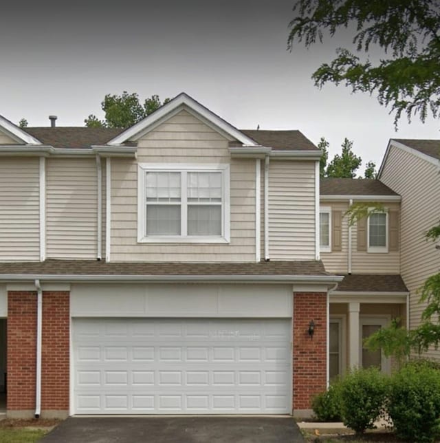 8501 Sawyer Ct, Joliet, IL 60431 - view of front facade with asphalt driveway, an attached garage, and brick siding