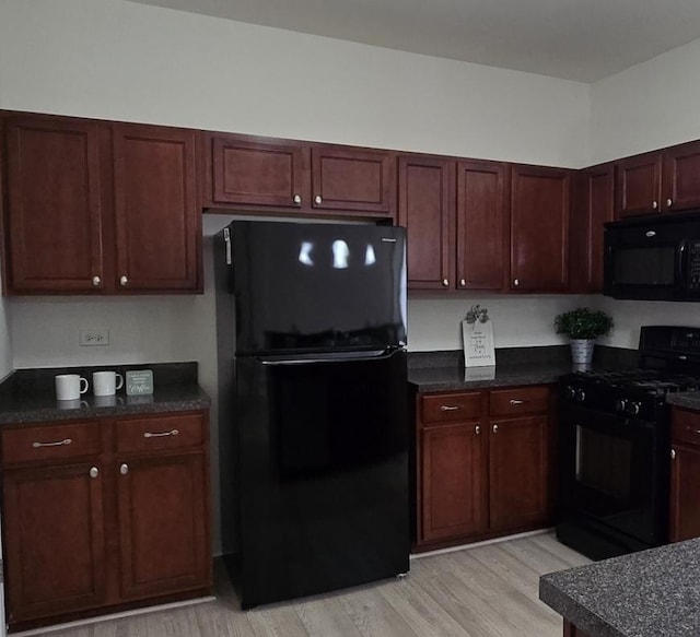 8501 Sawyer Ct, Joliet, IL 60431 - kitchen with black appliances, dark countertops, and light wood-type flooring