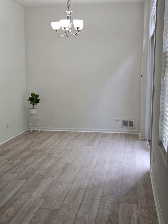 8501 Sawyer Ct, Joliet, IL 60431 - spare room featuring a chandelier and wood finished floors