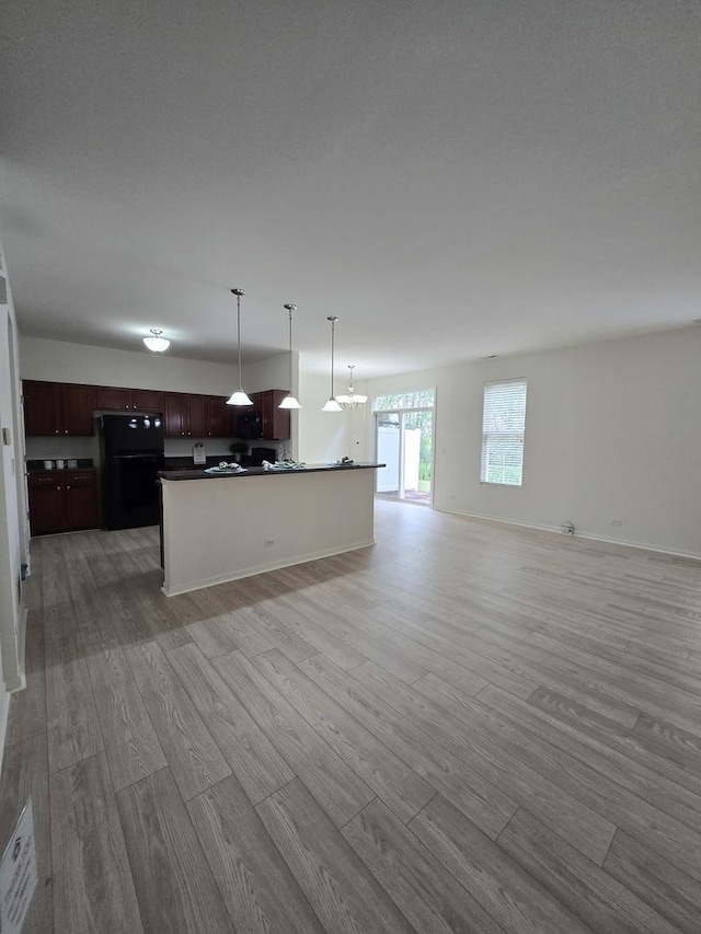 8501 Sawyer Ct, Joliet, IL 60431 - kitchen with freestanding refrigerator, light wood-style floors, open floor plan, and dark countertops
