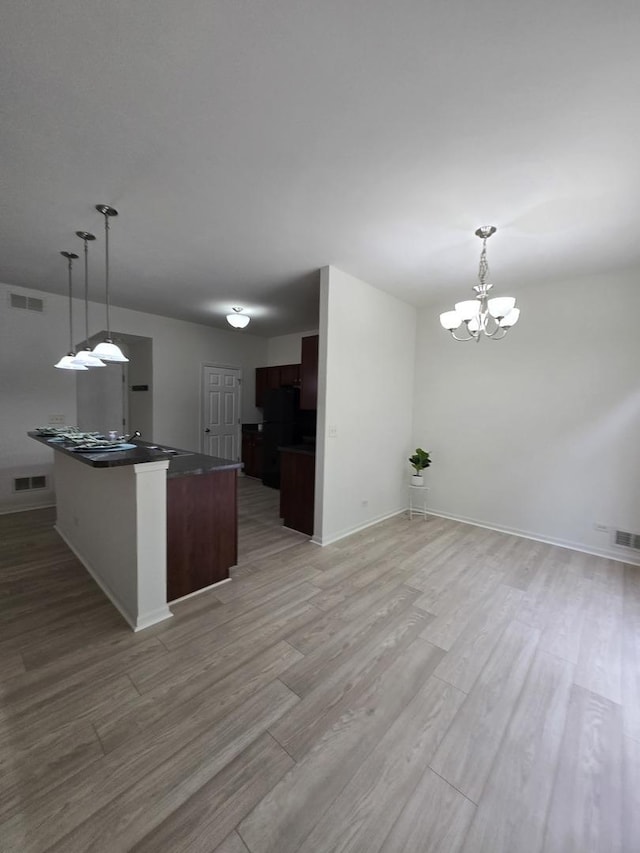 8501 Sawyer Ct, Joliet, IL 60431 - kitchen with dark countertops, light wood-style flooring, and decorative light fixtures