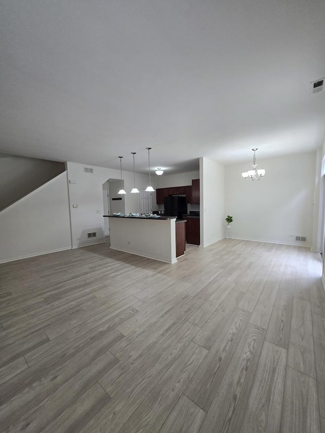 8501 Sawyer Ct, Joliet, IL 60431 - unfurnished living room with a chandelier and light wood-style floors