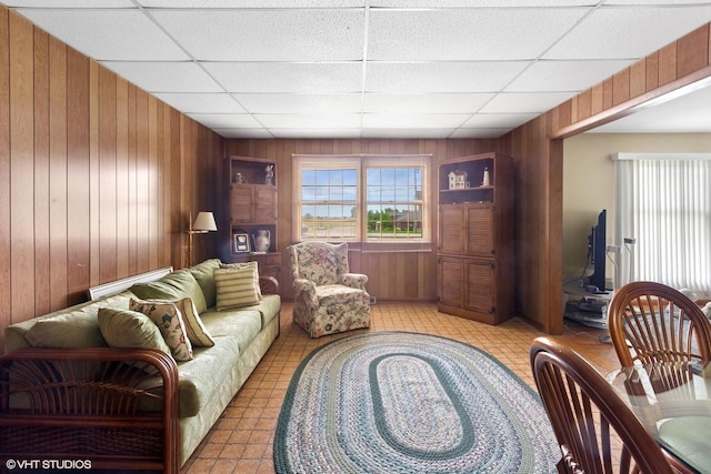 43W888 Hughes Rd, Elburn, IL 60119 - living room featuring wood walls, a paneled ceiling, and plenty of natural light