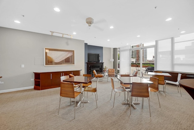 1600 S Prairie Ave Unit 1507, Chicago, IL 60616 - dining room featuring a fireplace, recessed lighting, a ceiling fan, a wall of windows, and light carpet