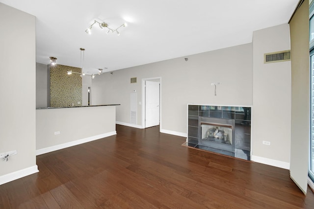 1600 S Prairie Ave Unit 1507, Chicago, IL 60616 - unfurnished living room featuring wood finished floors, a tile fireplace, and track lighting