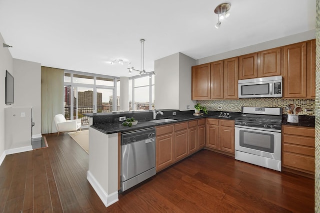 1600 S Prairie Ave Unit 1507, Chicago, IL 60616 - kitchen with stainless steel appliances, a peninsula, dark wood-type flooring, and backsplash