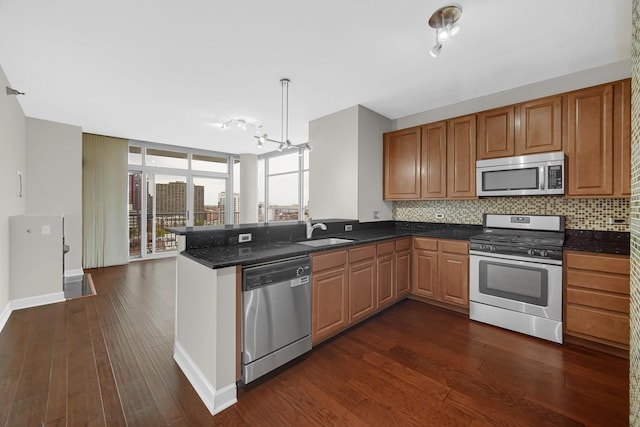 1600 S Prairie Ave Unit 1507, Chicago, IL 60616 - kitchen featuring stainless steel appliances, a peninsula, tasteful backsplash, dark wood-style floors, and a chandelier