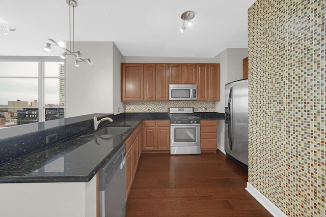 1600 S Prairie Ave Unit 1507, Chicago, IL 60616 - kitchen with appliances with stainless steel finishes, dark wood finished floors, a peninsula, dark stone counters, and backsplash