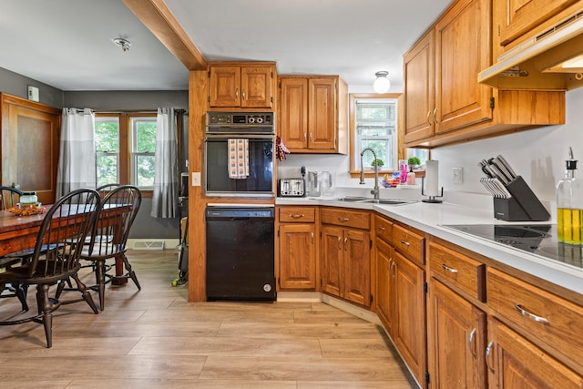 2070 County Road 2400, Thomasboro, IL 61878 - kitchen with black appliances, under cabinet range hood, and brown cabinets