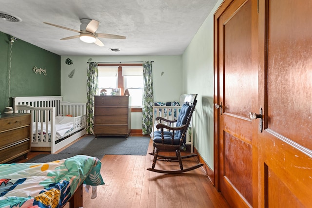 2070 County Road 2400, Thomasboro, IL 61878 - bedroom with wood-type flooring and a ceiling fan