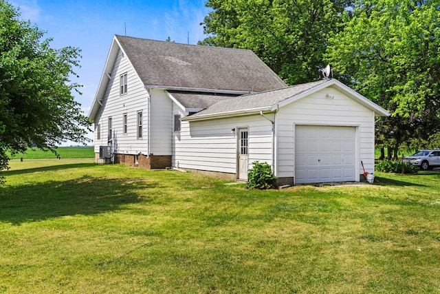 2070 County Road 2400, Thomasboro, IL 61878 - view of home's exterior with a shingled roof, a yard, and an attached garage