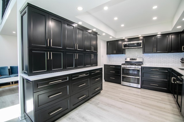 15705 Lake Hills Ct Unit 2N, Orland Park, IL 60462 - kitchen featuring stainless steel appliances, dark cabinets, light countertops, tasteful backsplash, and recessed lighting