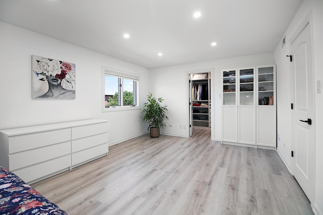 15705 Lake Hills Ct Unit 2N, Orland Park, IL 60462 - unfurnished bedroom featuring light wood finished floors, recessed lighting, a walk in closet, and a closet